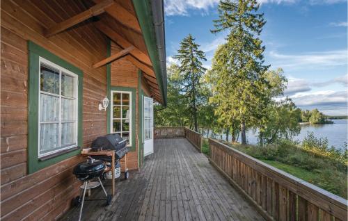 a wooden walkway on the side of a house at Lovely Home In Kvicksund With Sauna in Kvicksund