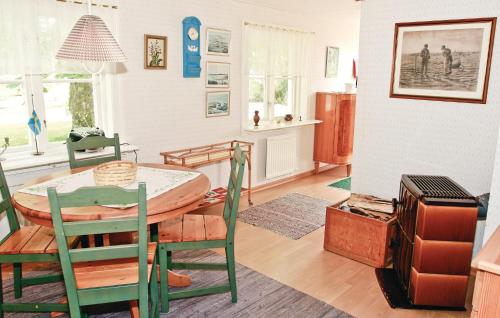 a living room with a table with a surfboard on it at Holiday Home Baggekulla Blidsberg in Tomten