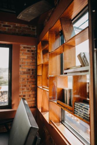 a room with a book shelf and a window at Vu's Homestay in Phong Nha