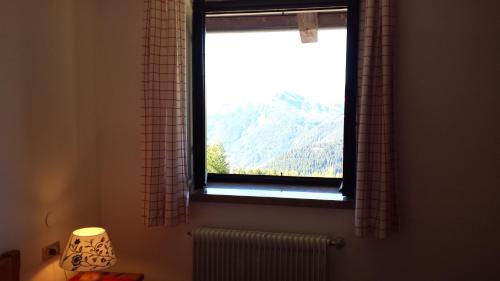 a window with a view of a mountain at Hotel Garni Gonzaga in Canazei