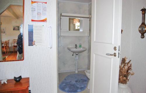 a bathroom with a toilet and a sink at Holiday Home Barkhult Ullared in Källsjö