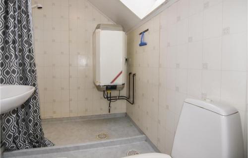 a small bathroom with a toilet and a sink at Beautiful Home In Dalum With Kitchen in Tomten