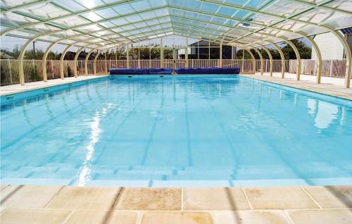 a large swimming pool with a glass roof at Nice Home In Grandcamp Maisy With Wifi in Grandcamp-Maisy