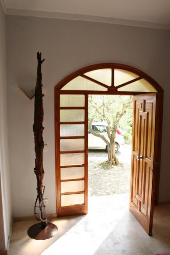 an open door in a room with a tree at Can Quilis in Pontós
