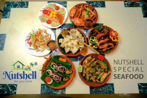 a bunch of plates of food on a table at Nutshell-Airport Retreat by the Sea in Trivandrum