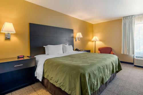A bed or beds in a room at Quality Inn & Suites Lenexa Kansas City