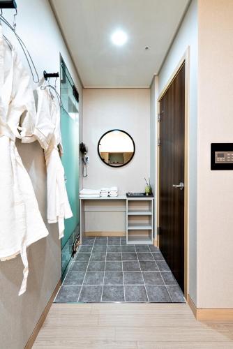 a bathroom with a sink and a mirror at Siheung Seoul Tourist Hotel in Siheung