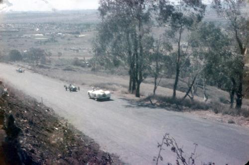 two cars driving down a road in a field at The Sampson - Orange in Orange