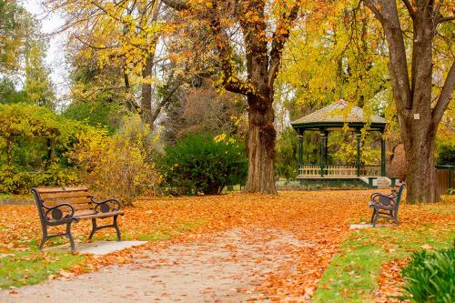 a park with two benches and a gazebo at The Sampson - Orange in Orange