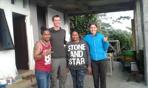 a group of men standing next to each other holding a sign at Kristian Homestay in Bajawa