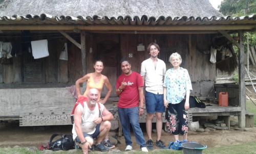 a group of people standing in front of a house at Kristian Homestay in Bajawa