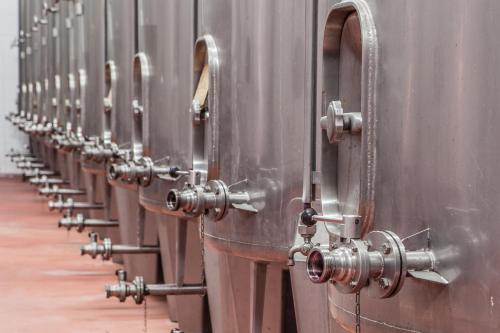a row of metal barrels lined up next to each other at Casa Lata - Agroturismo e Enoturismo in Amares