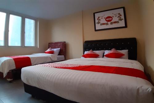 Een bed of bedden in een kamer bij OYO 1053 Angelyn Home Stay