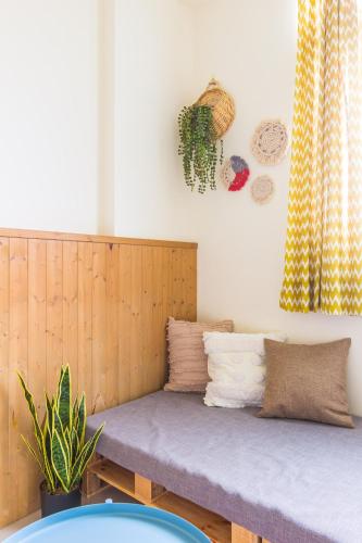 a bed in a room with a wooden headboard at Cozy Green Guesthouse in Taitung City