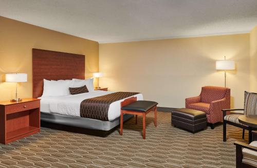 a hotel room with a bed and a chair at Best Western Plus Milwaukee Airport Hotel & Conference Center in Milwaukee