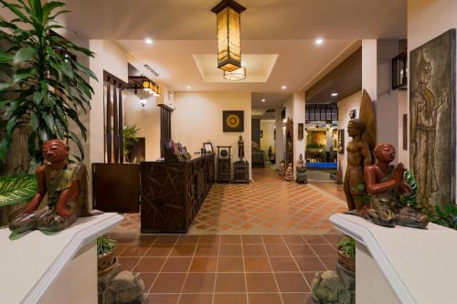 a lobby with statues on display in a building at Seeka Boutique Resort - Relaxing Stay - Balcony, Pool & Near Beach in Patong Beach