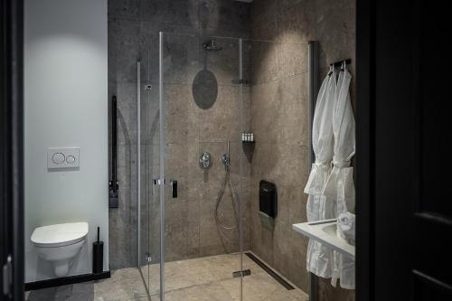 a bathroom with a shower and a toilet at Boutiquehotel 't Fraeyhuis - adults only in Bruges