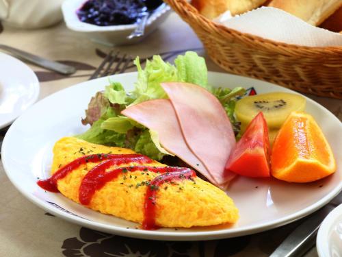 a plate of food with a sandwich and a salad at Hotel Mumon in Myoko