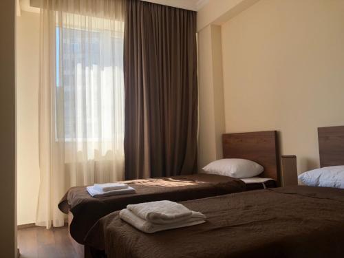 En eller flere senge i et værelse på Borjomi-Likani Premium Apartments