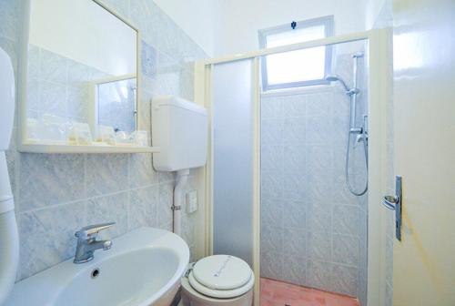 a bathroom with a toilet and a sink and a shower at Hotel Firenze in Bellaria-Igea Marina