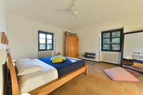 a bedroom with a large bed with a blue blanket at La Fornace in Alessandria