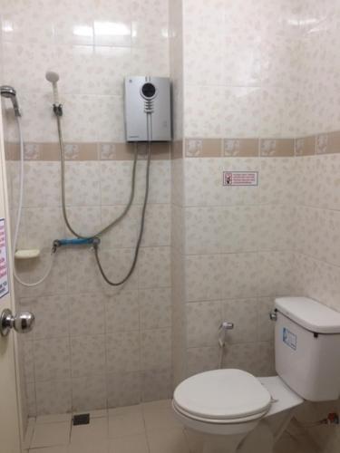 a bathroom with a shower with a toilet in it at Pikul Apartment Hotel in Nong Khai