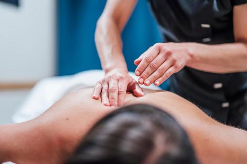 a man getting a massage from a therapist at Pernilla Wiberg Hotel in Idre