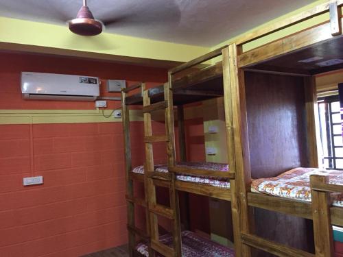 a room with two bunk beds in a building at Nimmu Guest House & Restaurant Gokarna in Gokarna