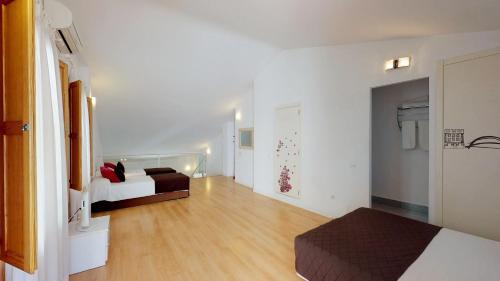 a large white room with a bed and a couch at Edificio Palomar - PalomarGroup in Valencia