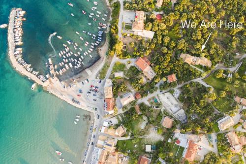 an overhead view of a beach with the words we are here at Villa Phoenix in Keri