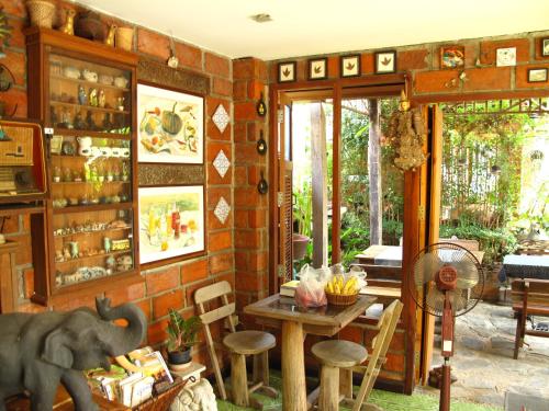 a room with a table and an elephant statue in it at P.Y. Guest House in Kanchanaburi
