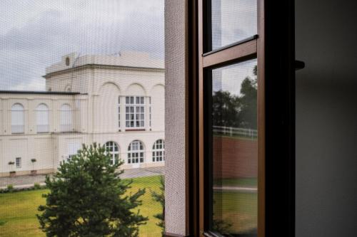 a view of a building from a window at HOTEL Hraniční zámeček in Hlohovec
