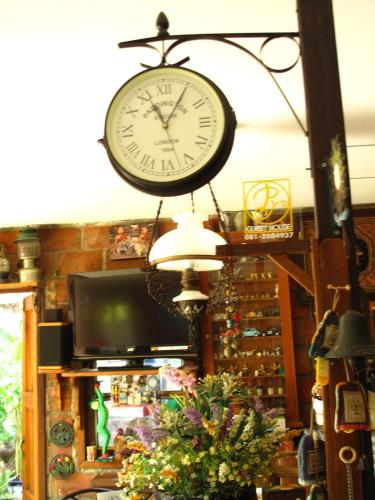 a clock hanging from the ceiling of a store at P.Y. Guest House in Kanchanaburi