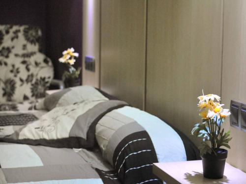 a bedroom with a bed and a table with flowers at BARCELONA GOTIC Guesthouse in Barcelona