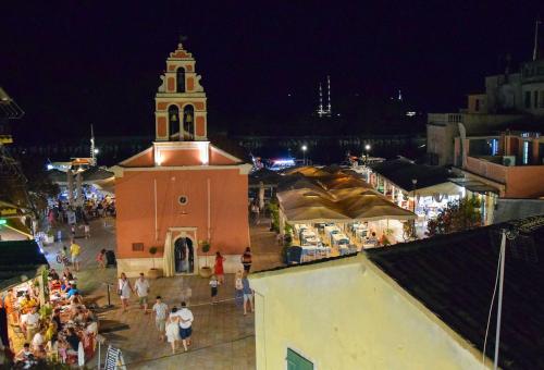 a group of people walking around a town at night at Aglaia V Studio in Gaios