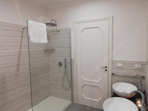 a bathroom with a shower and a toilet and a sink at Kaloneiro Guest House in Corigliano dʼOtranto