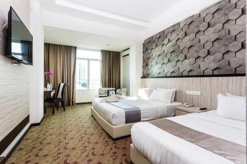 Tempat tidur dalam kamar di E-Red Hotel Melaka