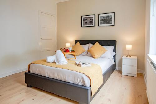 a bedroom with a bed with a table on it at Stirling Mercury Apartment - Scotland Holiday Let in Stirling