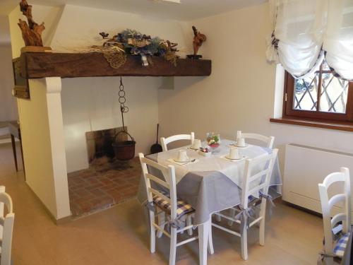 a dining room with a table and a fireplace at Villa Il Fortino in Lido di Camaiore