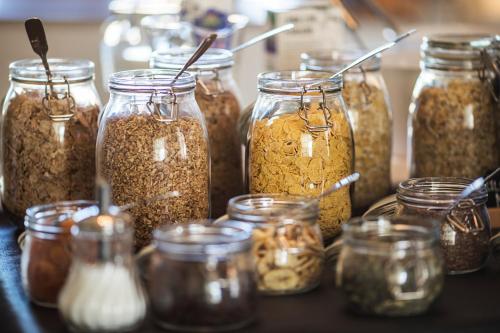 a group of jars of nuts and seeds on a table at Hotel Statt Söderhamn by First Hotels in Söderhamn