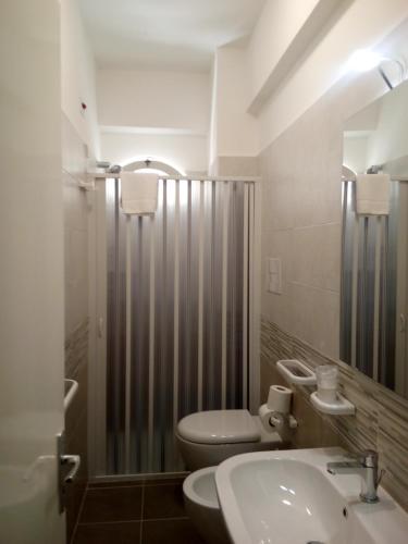 a bathroom with a sink and a toilet and a shower at Al Saliceto Hotel in Patti