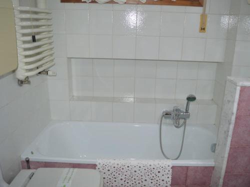 a bathroom with a white tub with a shower at A CASA DI GIANCARLA in Bologna