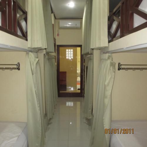 a room with two bunk beds and a hallway at Pondok Aldi Hostel in Amed