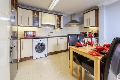 a kitchen with a table and a washing machine at Henry Court Townhouse in Kenmare