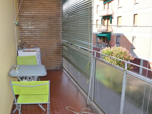 a balcony with two chairs and a table on a building at A CASA DI GIANCARLA in Bologna