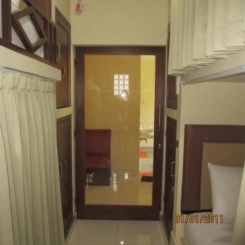 a hallway with a door leading to a room at Pondok Aldi Hostel in Amed