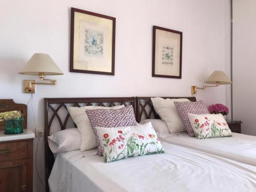 a bedroom with two beds with pillows on it at Beachfront oasis in Costa del Sol. in Caleta De Velez