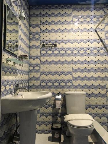 a bathroom with a toilet and a sink at Golden House in Anaklia