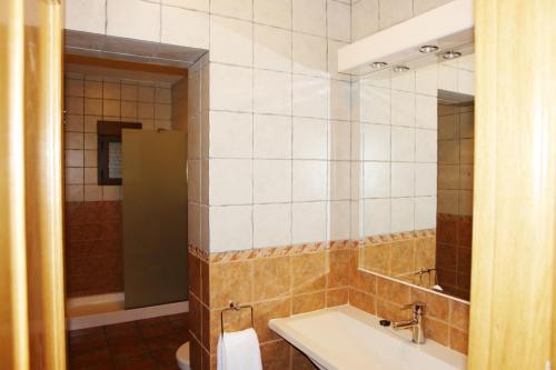 a bathroom with a sink and a mirror at Hotel Rural La villa Don Quijote in Cuenca