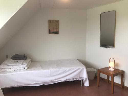 a bedroom with a white bed and a table at Brunbjerg Apartments in Billund